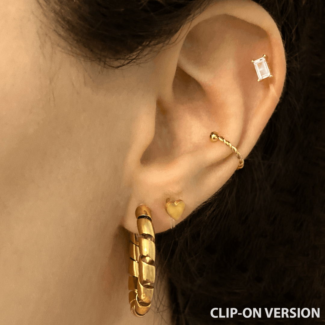 Mini heart stud clip on earrings in gold on the ear