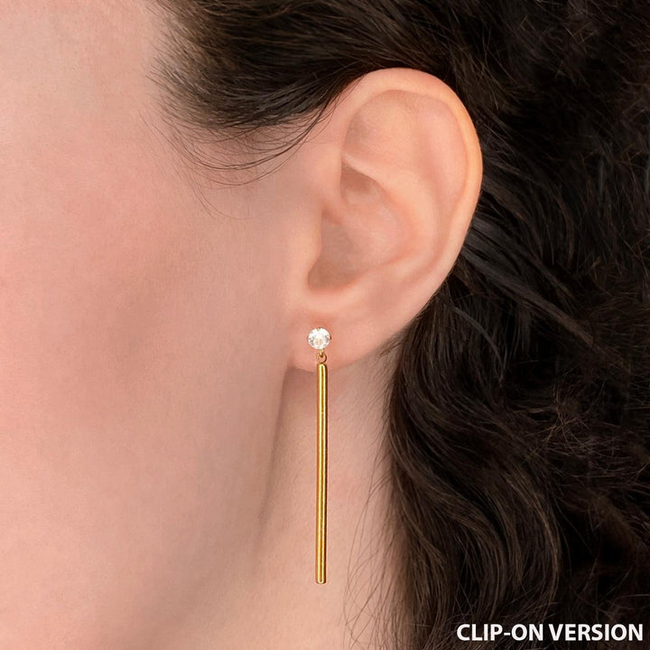 Cubic zirconia rhinestone dangle clip on earrings in gold worn on ear