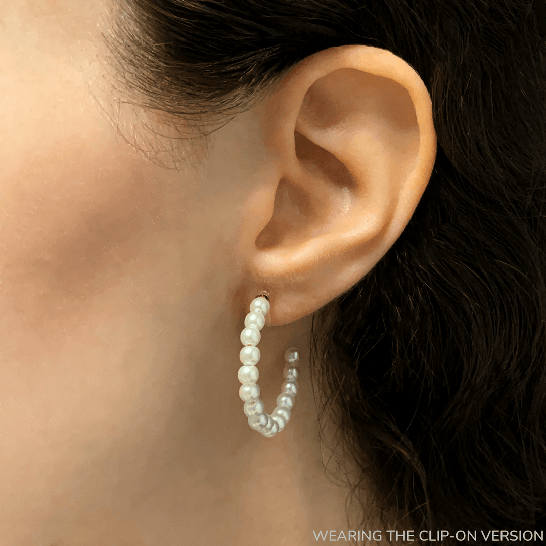 Pearl hoop clip on earrings in gold on the ear