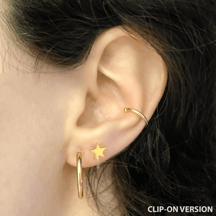 Star stud clip on earrings in gold worn on ear