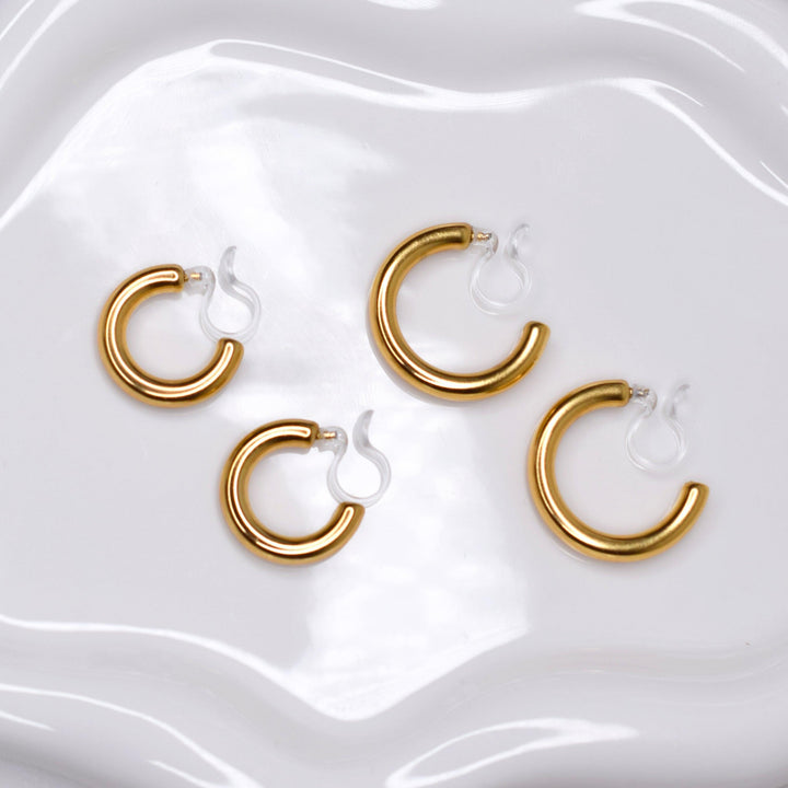 chunky huggie hoop clip on earrings in gold and chunky small hoop clip on earrings in gold