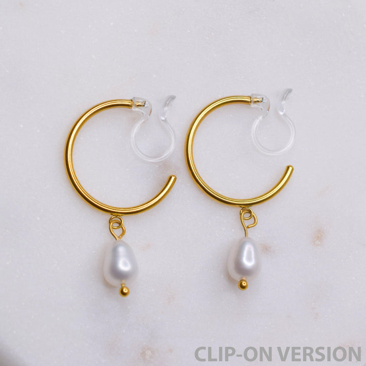 Thin small hoop clip on earrings in gold with real genuine freshwater pearl dangle showing the comfortable invisible clear hypoallergenic resin clip