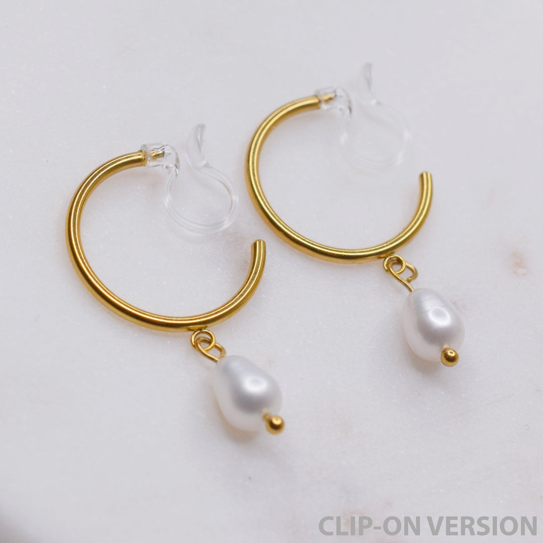Thin small hoop clip on earrings in gold with real genuine freshwater pearl dangle showing the hypoallergenic resin clear invisible clip