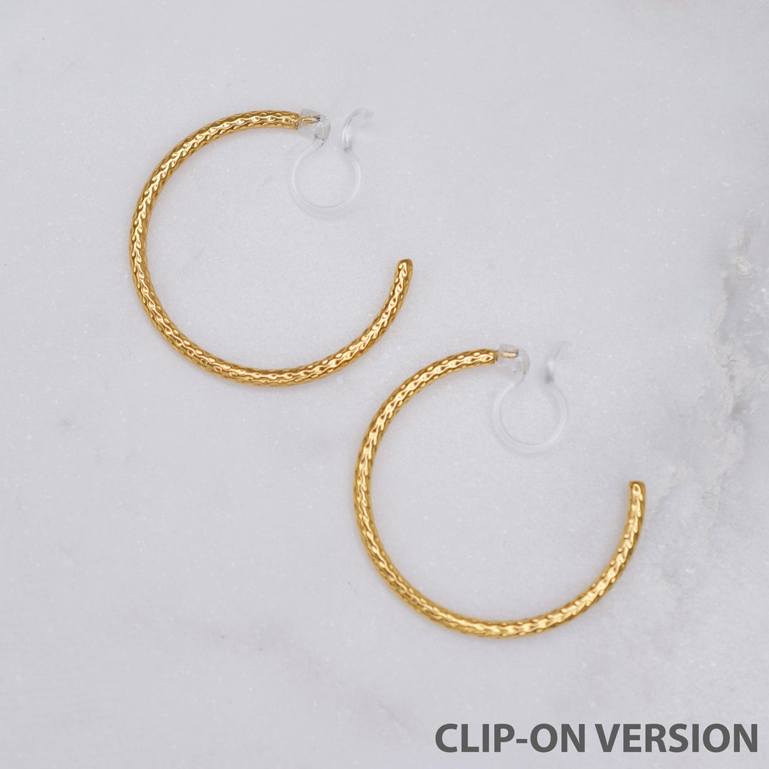 Thin medium size textured hoop clip on earrings in gold with the comfortable invisible clear resin clip