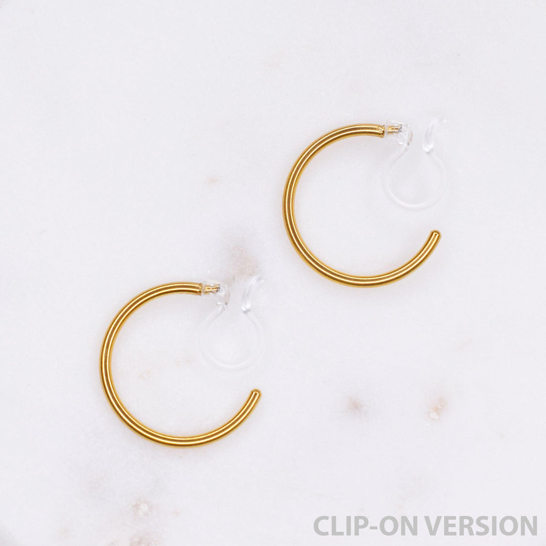 Thin small hoop clip on earrings in gold with the comfortable invisible clear hypoallergenic resin clip