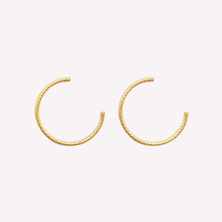 Thin medium size textured hoop clip on earrings in gold