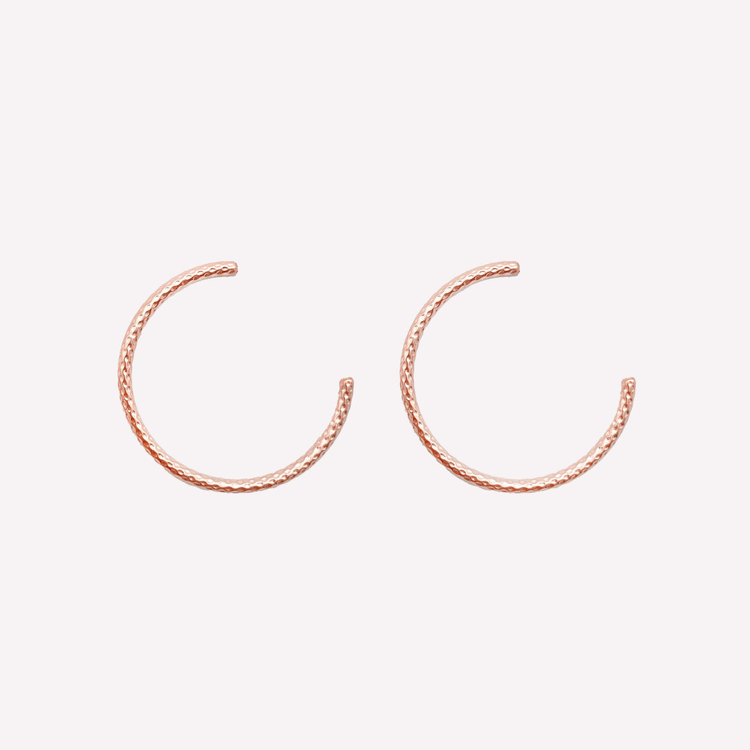 Thin medium size textured hoop clip on earrings in rose gold