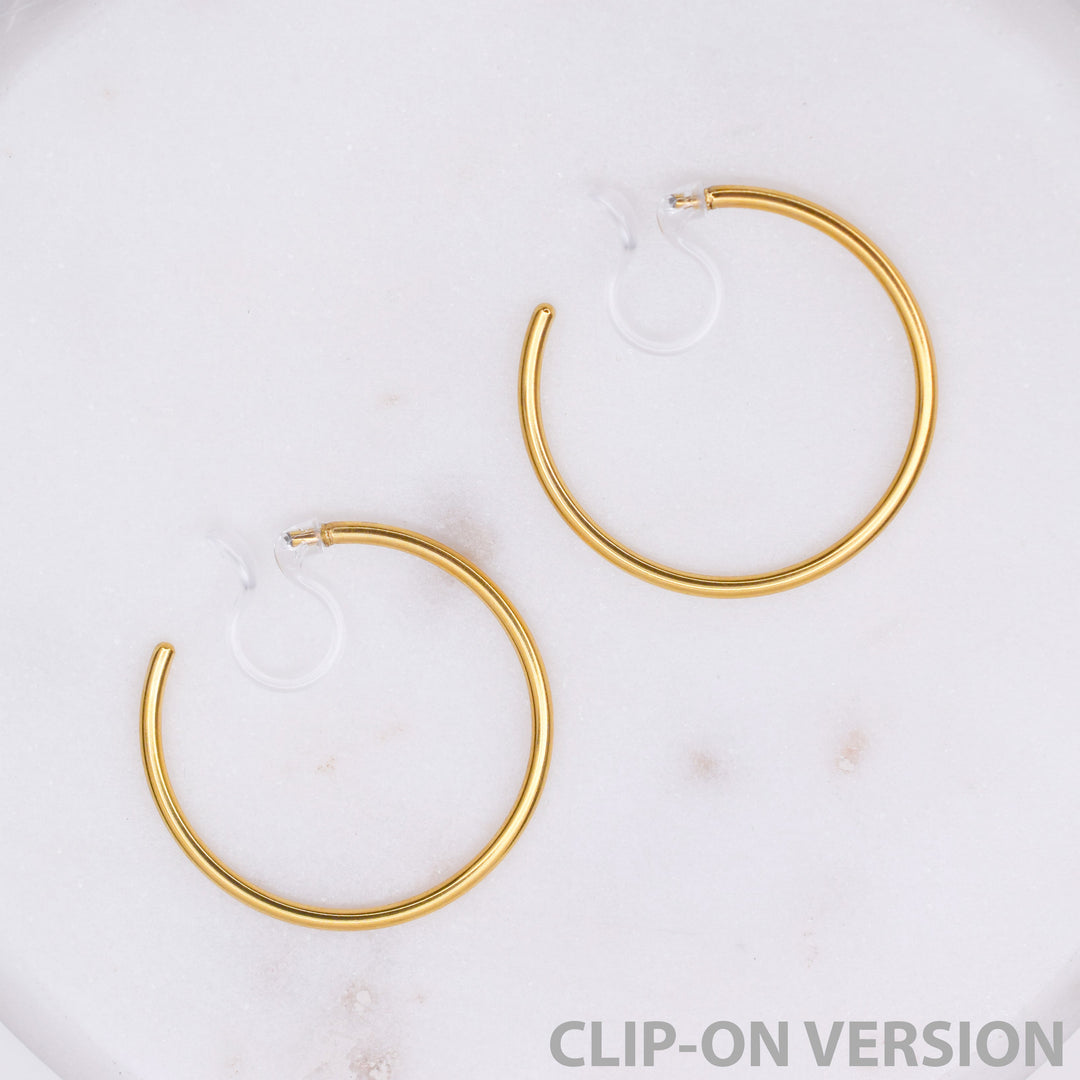 Thin medium hoop clip on earrings in gold
