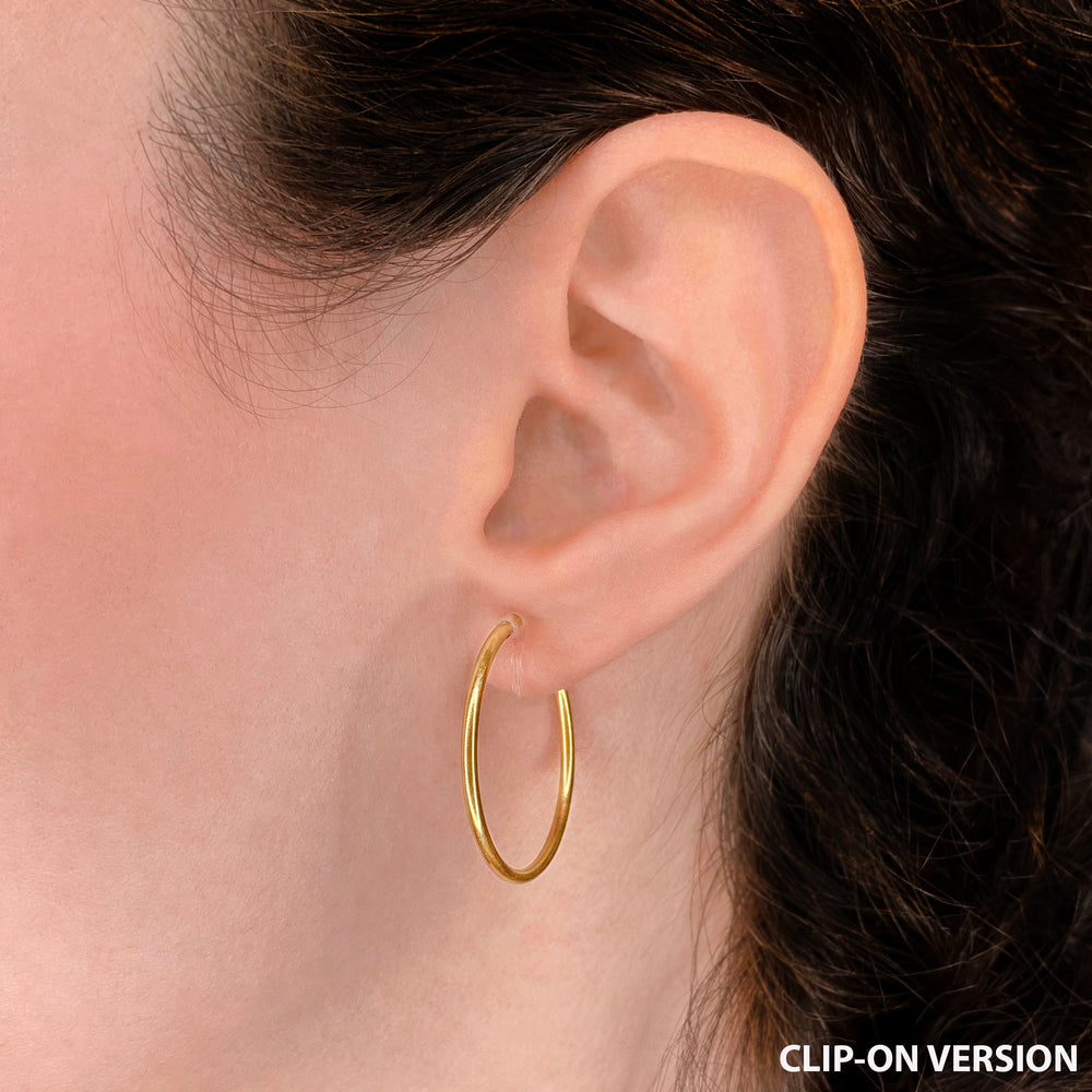thin medium hoop clip on earrings in gold