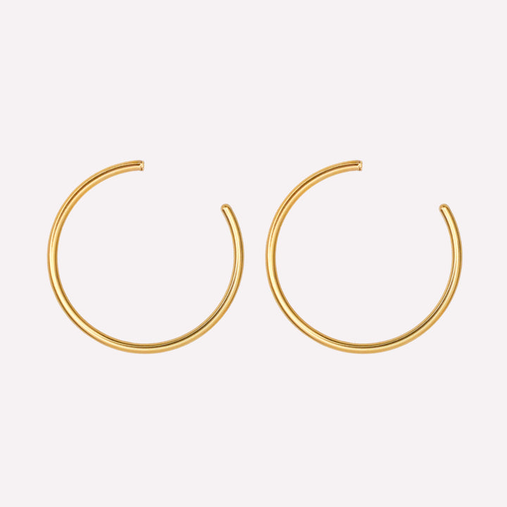 Thin medium hoop clip on earrings in gold