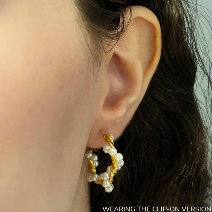 Twist pearl design hoop clip on earrings in gold worn on ear